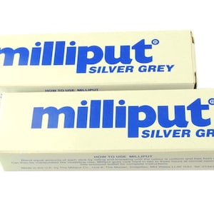 May include: Two boxes of Milliput Silver Grey epoxy putty. The boxes are white with blue lettering. The text on the box reads "Milliput Silver Grey" and "How to Use Milliput".