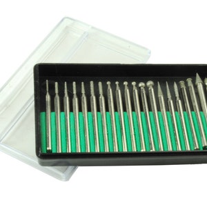 May include: A set of 20 diamond-tipped rotary tools in a clear plastic case. The tools are arranged in a black plastic tray with a green foam insert.