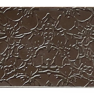 May include: A dark brown chocolate bar with an embossed floral design.