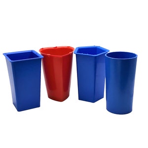 May include: Four plastic containers in different shapes: a square, a heart, a hexagon, and a cylinder. The square and cylinder containers are blue, while the heart and hexagon containers are red.