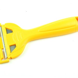 May include: A yellow plastic scraper with a handle and a replaceable blade. The blade is partially visible and has a silver finish.