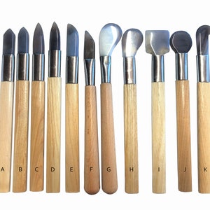 May include: Set of 11 pottery tools with wooden handles and various metal tips. The tools are labelled A through K.