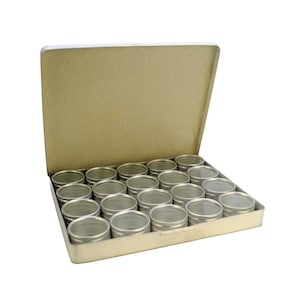 May include: A silver metal box with a hinged lid, containing 20 small, round, silver containers with clear lids. The box is open and the containers are arranged in rows.