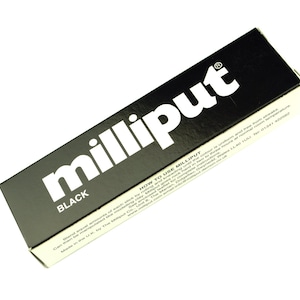 May include: Black rectangular box with the word "milliput" in white lettering. The word "BLACK" is printed below the logo. The box also includes instructions and contact information. The product is made in the U.K.
