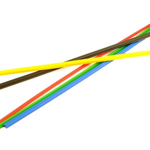 May include: Five colourful plastic drinking straws, including yellow, black, red, green, and blue, are arranged in a criss-cross pattern on a white background.