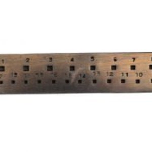 May include: A metal gauge with numbered holes, labelled "STAWRA" and numbered 1 through 8. The gauge is used for measuring the size of jewellery.