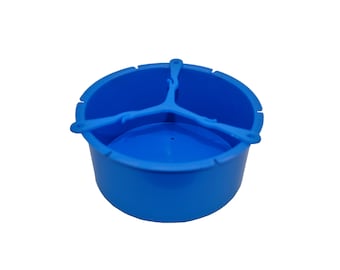 May include: A blue plastic three-sectioned feeder for birds or small animals. The feeder has a round base and three dividers that create separate compartments.