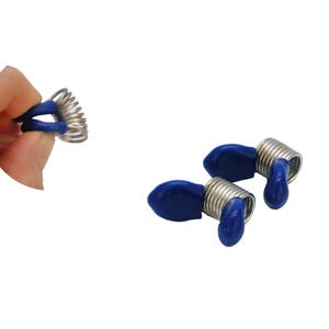 May include: Two blue and silver spring-loaded thread holders. The thread holders are designed to hold thread spools in place.