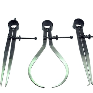 May include: Three black metal calipers with adjustable arms and a sliding scale. The calipers are used for measuring the inside and outside diameters of objects.