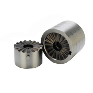 May include: Two silver metal tools with a gear-like design. The tools are used for crimping or pressing metal.