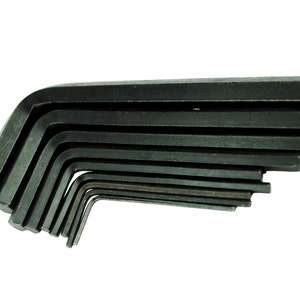 May include: A set of black Allen keys of various sizes, stacked in a fan shape.