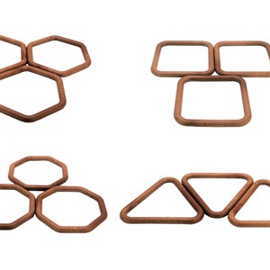 May include: Set of wooden frames in various shapes, including hexagons, squares, and triangles. The frames are all brown and have a smooth finish.