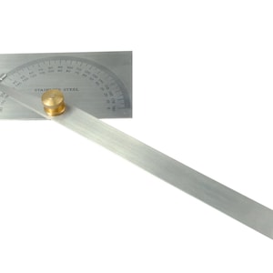 May include: A silver protractor with a brass knob and a long ruler attached. The protractor has markings in degrees from 0 to 180. The ruler is marked in inches. The protractor is labeled "Stainless Steel".