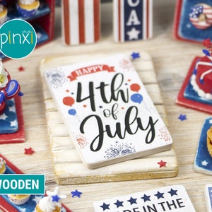 May include: A white wooden sign with the text "Happy 4th of July" in black lettering. The sign is decorated with red, white, and blue stars and fireworks. The sign is sitting on a white wooden surface.