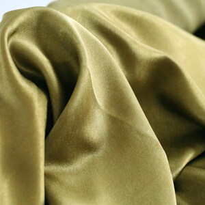 May include: A set of three ceramic mugs with a speckled, cream-colored glaze. Each mug features a different hand-painted floral design in shades of blue, green, and yellow. The mugs have a simple, rounded shape and a comfortable handle.