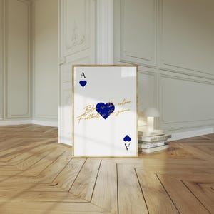 May include: Framed art print featuring a playing card design. The white card has a gold border and displays the Ace of Hearts with blue heart symbols. Text in gold script reads "Blue is the colour, Football is the game."