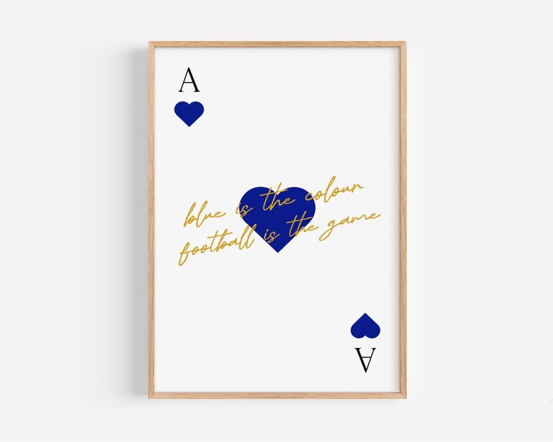 May include: A framed art print featuring a white background with a playing card design. The Ace of Hearts is depicted with blue hearts and the text "blue is the colour football is the game" in gold script. The frame is a light wood color.