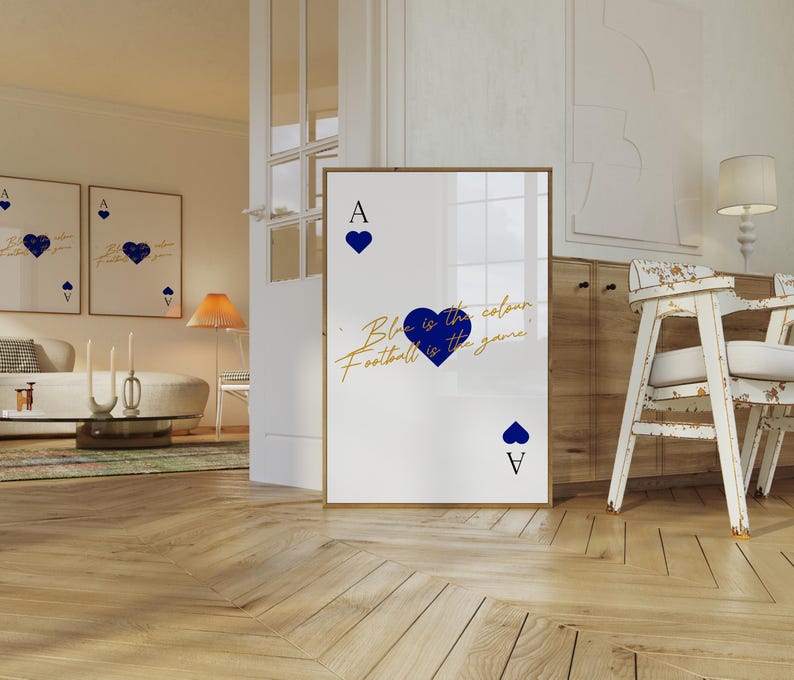 May include: A framed art print featuring a playing card design with a blue heart suit. The text "Blue is the colour, Football is the game" is written in gold script. The Ace of Hearts is displayed.