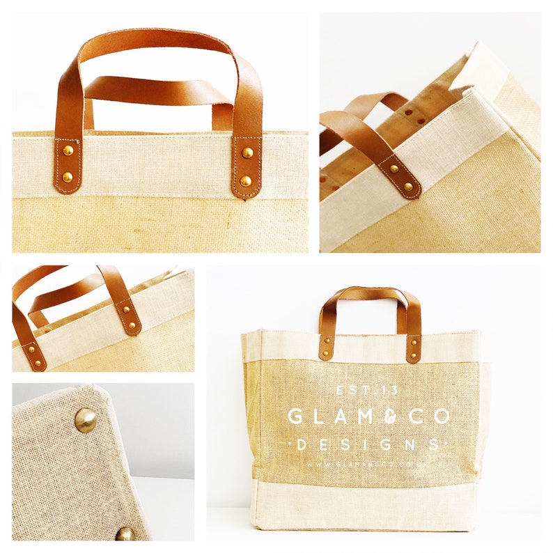 May include: A beige and white tote bag with brown leather handles and gold metal accents. The bag has the text "EST 13 GLAM & CO DESIGNS" printed on the front.