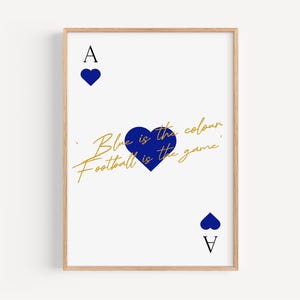 May include: Framed art print featuring a playing card design with a blue heart and the text "Blue is the colour, Football is the game" in gold script. The artwork is set against a white background.