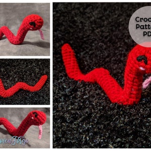 May include: A crocheted red snake with black eyes and a pink tongue. The snake is curled up on a black background. Crochet Pattern PDF.