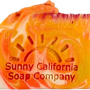 May include: A bar of orange, yellow, and white swirl soap with a sun design and the text "Sunny California Soap Company" on the front.