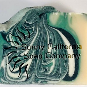 May include: A bar of green and white swirl soap with the text "Sunny California Soap Company" embossed on the top.