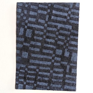 May include: A dark blue fabric with a woven pattern of horizontal and vertical lines. The fabric has a textured surface.