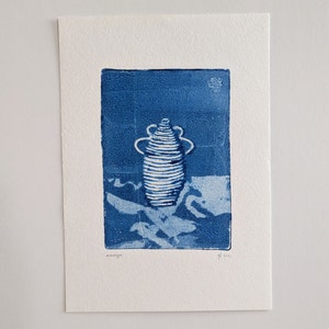 May include: A blue and white monotype print of a vase with a swirling design. The print is signed and dated "monotype" and "2021".