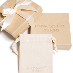 janna Conner branded jewelry pouch and recycled paper box with ribbon gift wrap