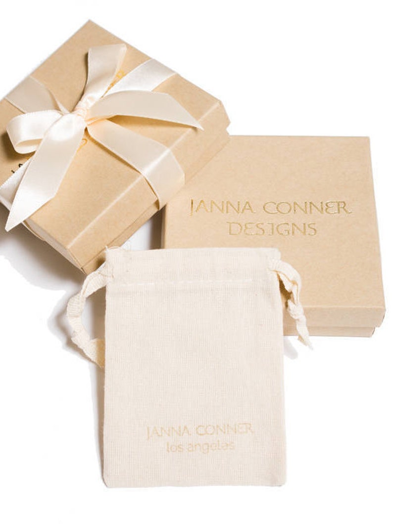 janna Conner branded jewelry pouch and recycled paper box with ribbon gift wrap