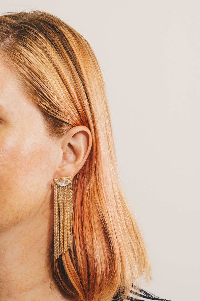 gold fringe earring jackets with crystal stud earrings on strawberry blonde model