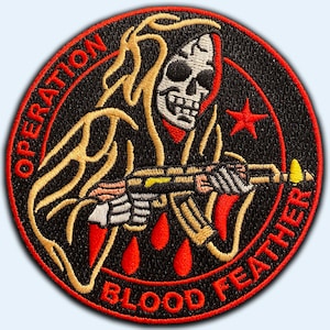 May include: A black embroidered patch with a red border. The patch features a skeleton wearing a red hooded robe holding a gun. The text "OPERATION BLOOD FEATHER" is written around the edge of the patch.