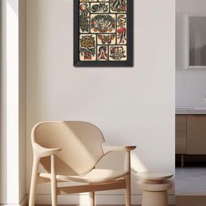May include: A framed print of a traditional tattoo flash sheet with various designs, including a tiger, skull, eagle, peacock, butterfly, heart, flowers, and a woman with a flower in her hair.