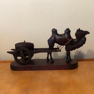 Camel Pulling Wagon Sculpture