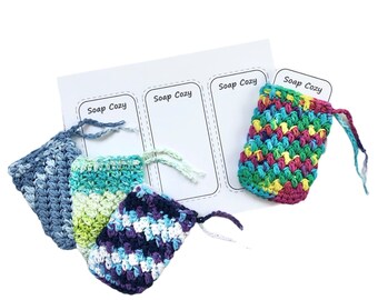 May include: Four crocheted soap cozies in different colours and patterns. The cozies are made with a variety of yarn colours, including blue, green, purple, and pink. The cozies are labelled "Soap Cozy" on a white sheet of paper.