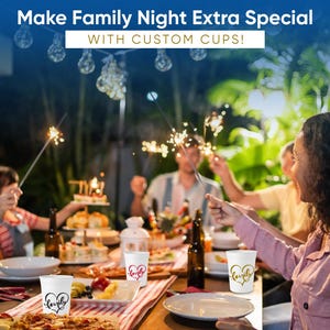 May include: A family gathering with custom cups. The white cups have heart-shaped designs with the word "lovely" in various colors. The scene includes food, drinks, and sparklers, with the text "Make Family Night Extra Special with Custom Cups!"