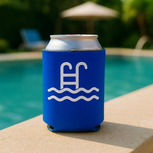 May include: A blue can cooler with a white pool graphic. The design features a pool ladder above wavy lines, suggesting water. The cooler is designed to keep beverages cold and is shown next to a pool.