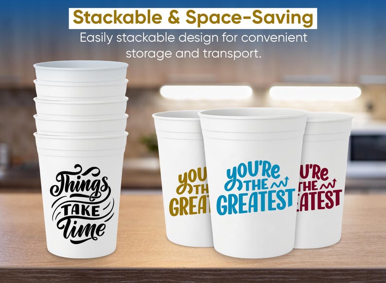 May include: White stackable plastic cups with various phrases printed on them, including "Things Take Time" in black, and "You're the Greatest" in blue. The cups are designed for convenient storage.