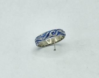 Titanium ring Deep Sea Blue coloured, with flowing, rippling, Surf design.