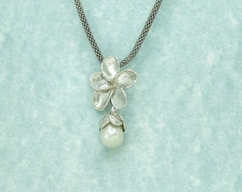 Frangipani Blossom Pendant, with a drop shaped fresh water pearl, in solid sterling silver.
