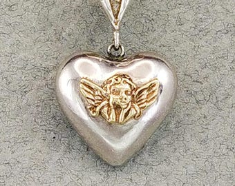 Heart Pendant, Angel Heart. 9K gold Angel set on a full heart in sterling silver.