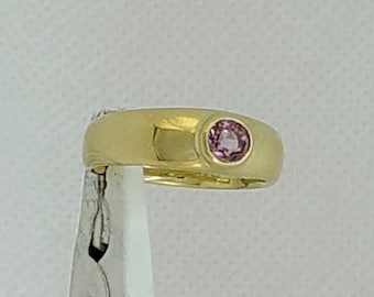 Pink Spinel set in a smooth, low profile, tapered band ring. In solid 9 k gold