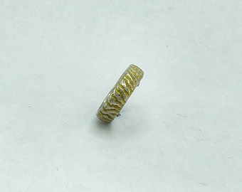 Titanium ring , golden coloured sand, with a windswept  rippling, wavy design.
