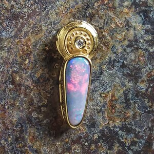 Australian Black Fire Opal Pendant in solid 18 carat gold set with a brilliant diamond highlight
