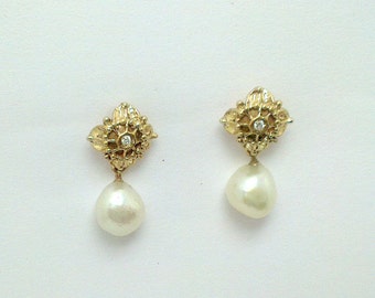 Delicate Flower shaped earring studs with Fresh Water Baroque Pearls  & set with diamonds. Solid  9 carat gold.