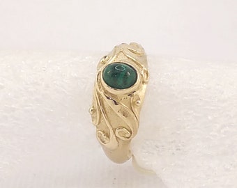 Cabochon cut Natural Colombian Emerald Dress Ring set in a solid 9 K gold hand carved flowing design around the stone.