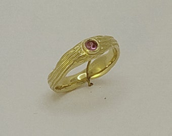 Pink Sapphire cabochon cut set in a hand carved flowing design. In solid 9 carat gold