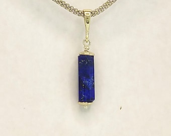 Lapis lazuli octagonal cylinder pendant, with 9 K white gold terminals and bail.