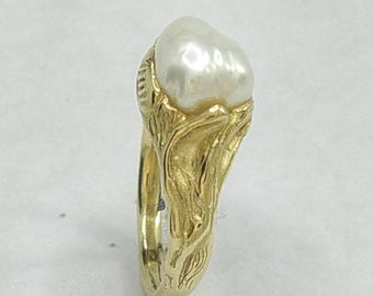 Baroque Pearl ring in a hand carved setting in 9 k gold with a flowing sea inspired design.